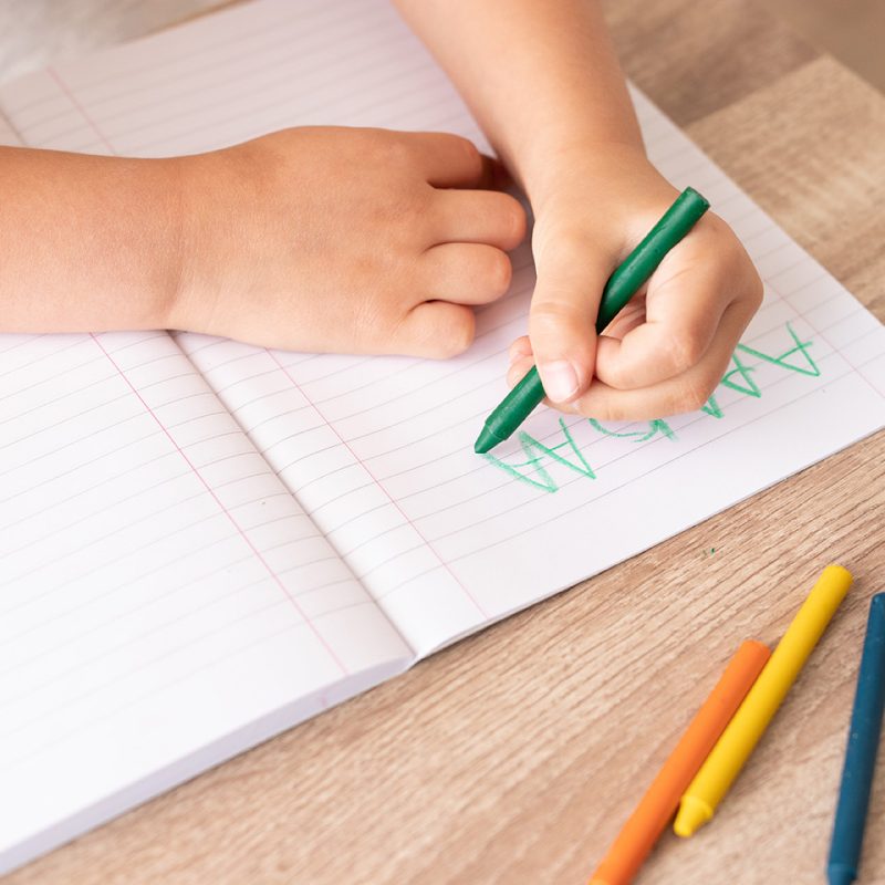 boy writing in a notepad