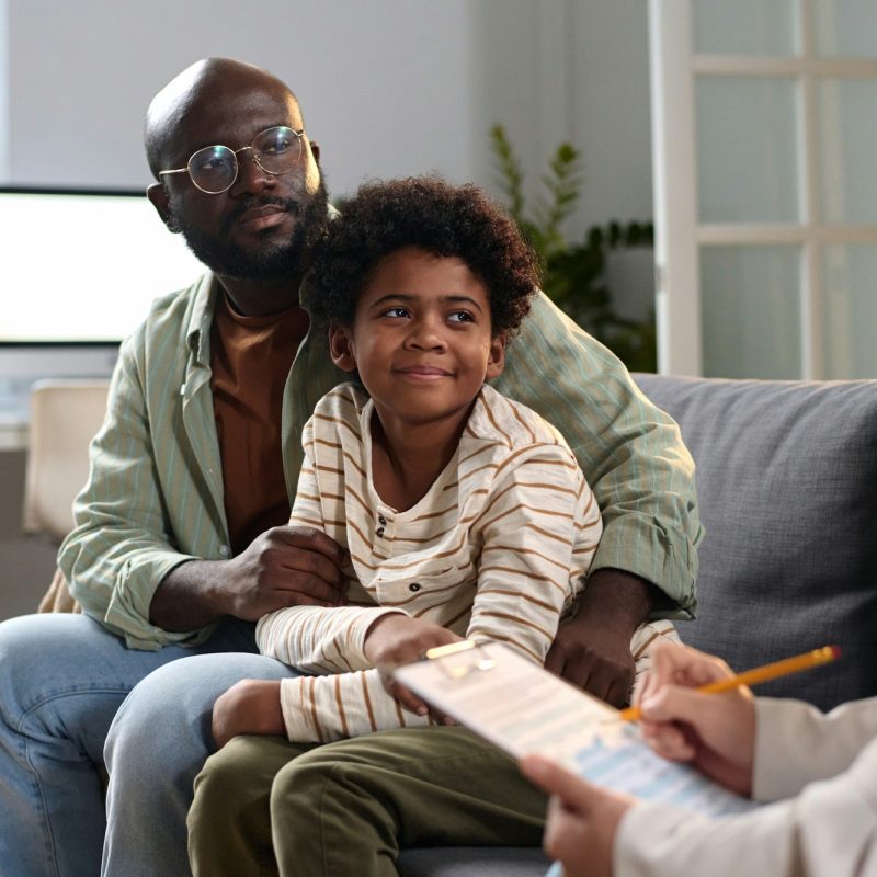 Happy Father and Son in Consultation with Lawyer