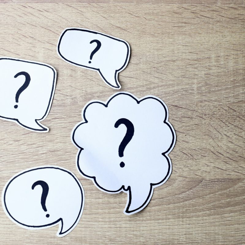 Question mark on wooden background